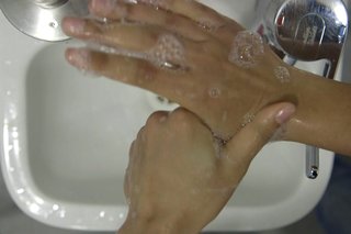 image of cleaning right thumb over the sink