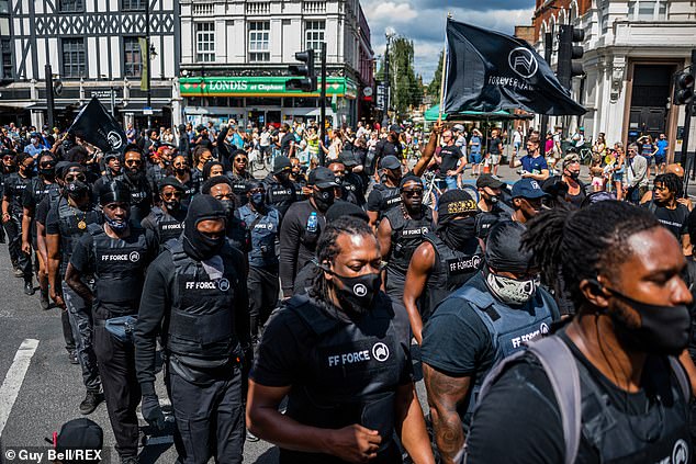 Wearing what appeared to be stab vests with paramilitary-style black uniforms, demonstrators marched through London yesterday demanding Britain make amends for generations of African slavery