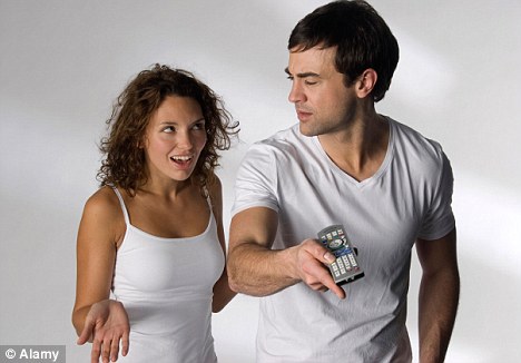 Man and woman argue over TV remote (posed by models)