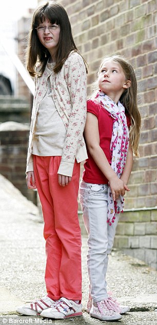 Growing up: Sophie, aged just six, already towers over her friend Daisy due to Marfan Syndrome