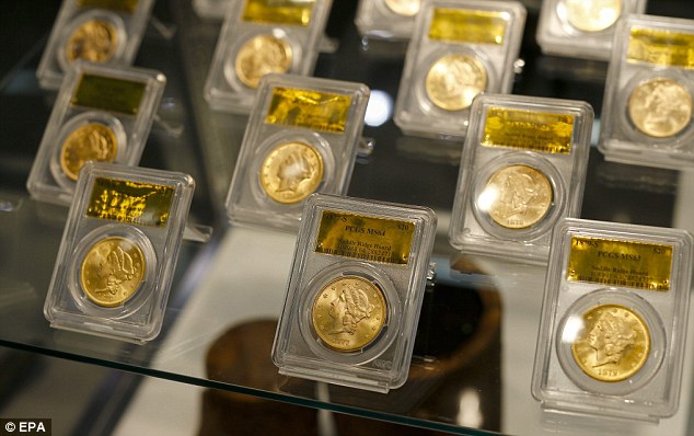Gold coins gleam in a display case showing a portion of the Saddle Ridge Hoard coin collection: The couple who found the $10m bounty could face censure under Californian Law if they failed to tell the authorities