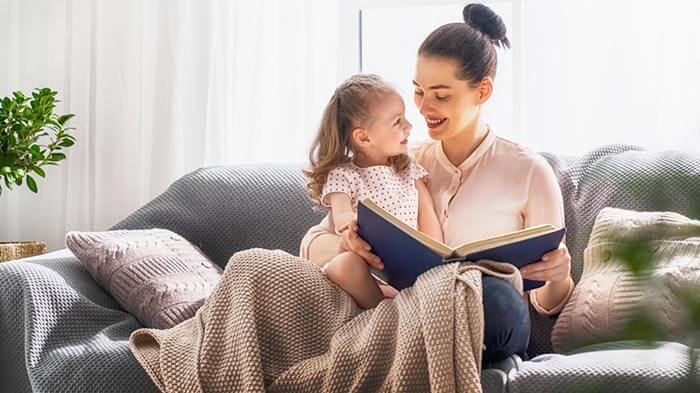 The young mother read a book to her daughter